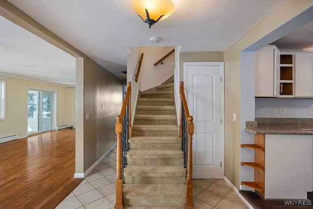 2202 River Rd, Wheatfield, NY 14304 - stairs featuring baseboards, wood finished floors, and a baseboard heating unit