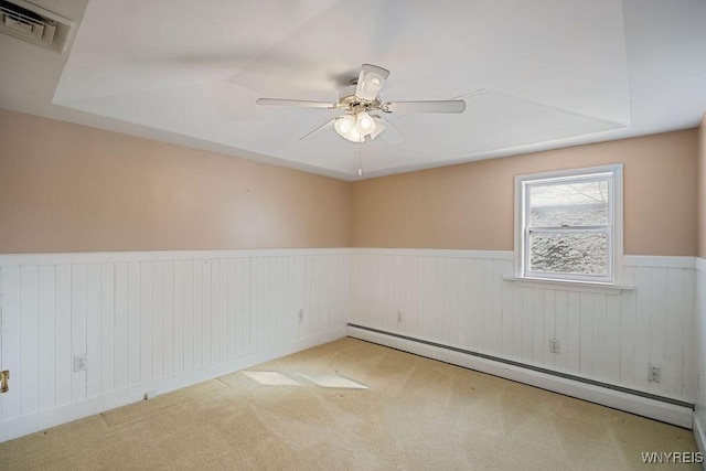 2202 River Rd, Wheatfield, NY 14304 - carpeted empty room with wainscoting, ceiling fan, and baseboard heating
