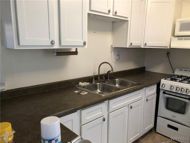 2202 River Rd, Wheatfield, NY 14304 - kitchen featuring white appliances, under cabinet range hood, a sink, and white cabinetry