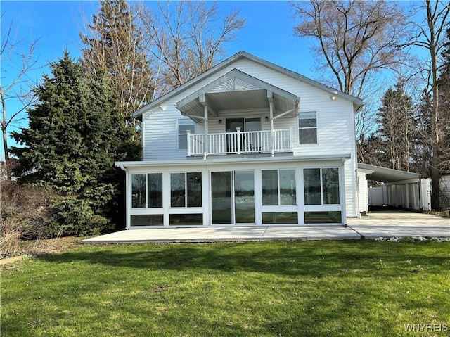 2202 River Rd, Wheatfield, NY 14304 - back of house with a balcony, a yard, an attached carport, and driveway