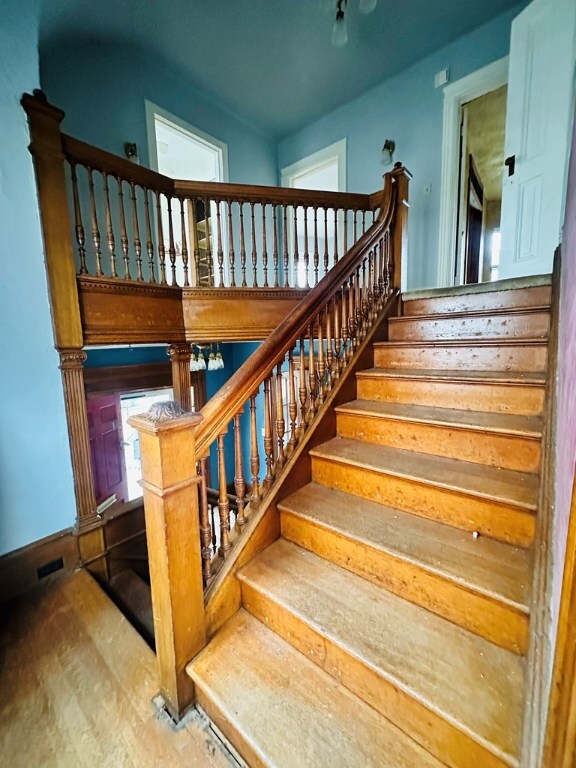 staircase featuring hardwood / wood-style flooring