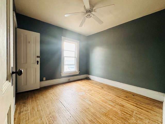 unfurnished room with ceiling fan and light wood-type flooring