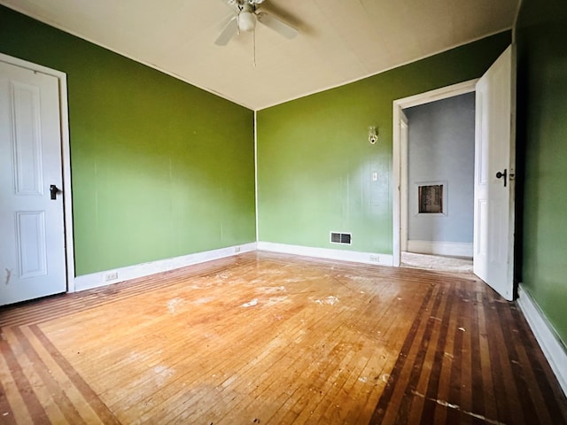 unfurnished room with hardwood / wood-style flooring and ceiling fan