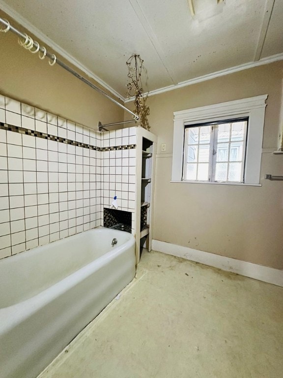 bathroom featuring ornamental molding, tiled shower / bath combo, and concrete floors