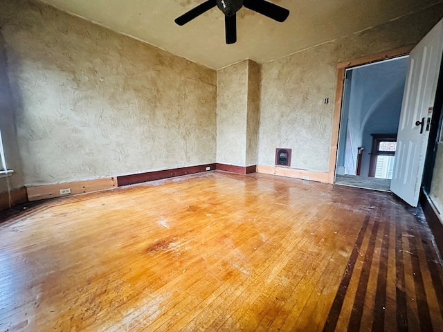 empty room with wood-type flooring and ceiling fan