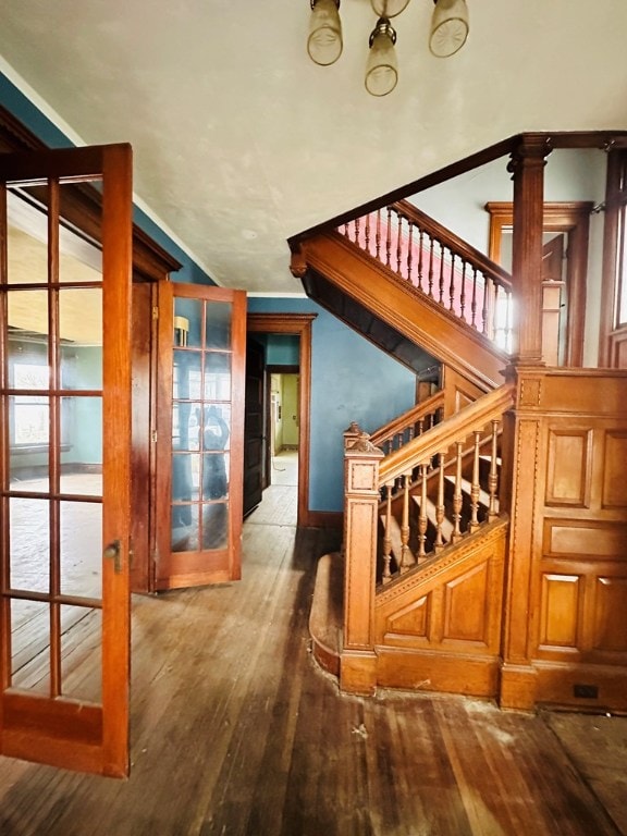 staircase with vaulted ceiling and hardwood / wood-style floors