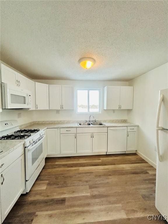 kitchen featuring white cabinetry, sink, white appliances, and light hardwood / wood-style flooring