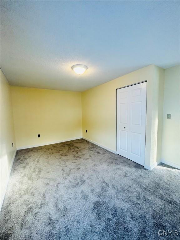 unfurnished bedroom featuring a closet and carpet flooring