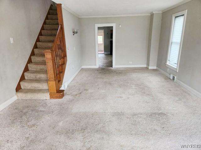 17 Beattie Ave, Lockport-City, NY 14094 - unfurnished living room featuring stairs, crown molding, carpet, and visible vents