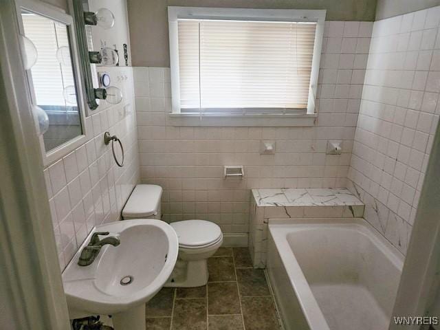 17 Beattie Ave, Lockport-City, NY 14094 - full bath featuring a sink, tile patterned floors, toilet, tile walls, and a washtub