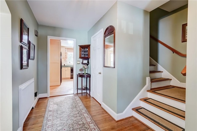 corridor with light hardwood / wood-style floors