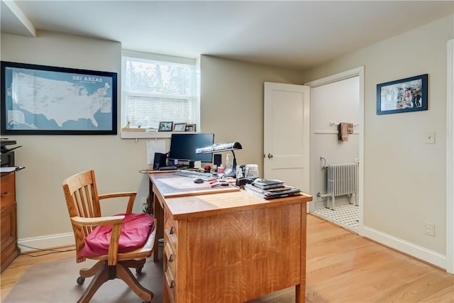 office area featuring light hardwood / wood-style flooring and radiator heating unit