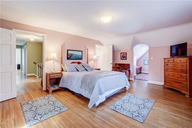 bedroom featuring light hardwood / wood-style flooring and vaulted ceiling