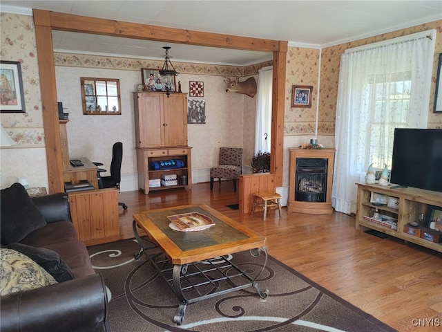 living room with hardwood / wood-style flooring and crown molding