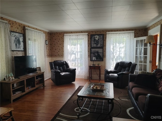 living room featuring hardwood / wood-style flooring, ornamental molding, and a wealth of natural light