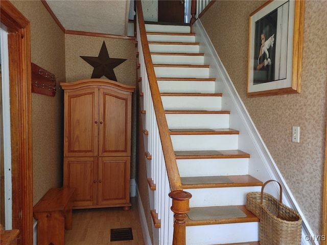 stairway with hardwood / wood-style flooring