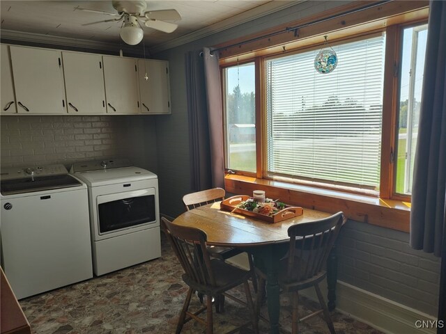 laundry room with cabinets, ornamental molding, ceiling fan, and washer and clothes dryer