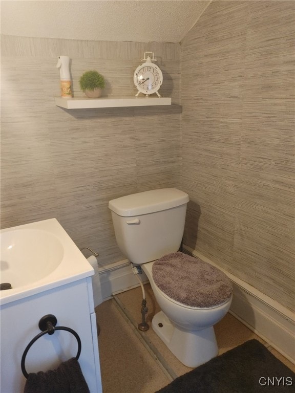 bathroom featuring vanity, vaulted ceiling, and toilet