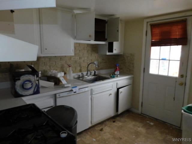 kitchen with tasteful backsplash, dishwasher, sink, white cabinets, and black gas range