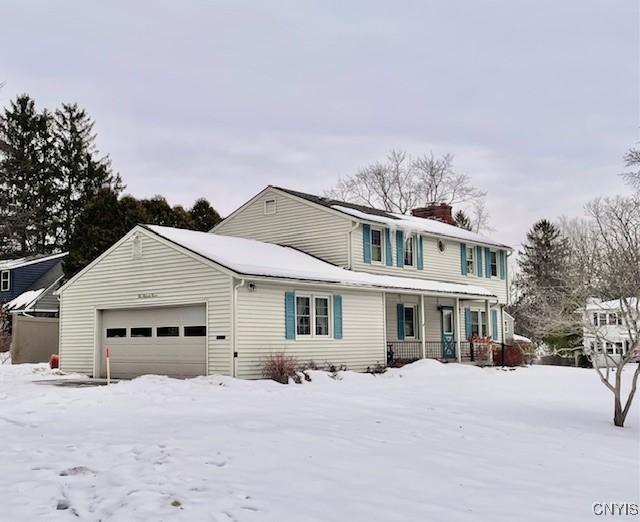 view of front property featuring a garage and a porch