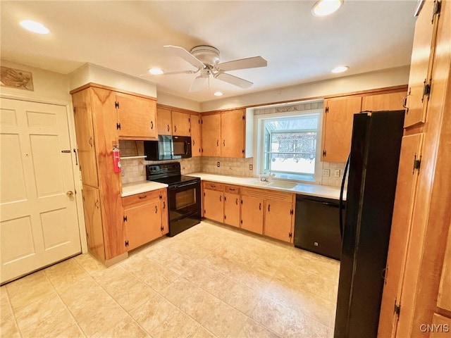 kitchen with ceiling fan, sink, decorative backsplash, and black appliances