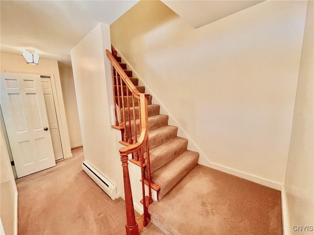 stairs with a baseboard radiator and carpet