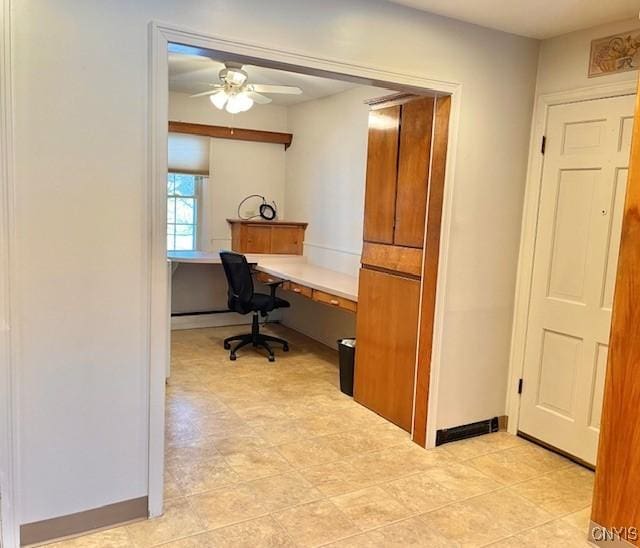 office area with ceiling fan and built in desk