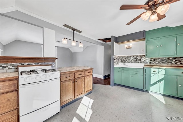 kitchen with lofted ceiling, backsplash, white range with gas stovetop, and green cabinets