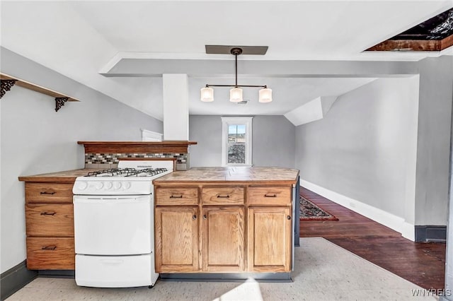 kitchen featuring pendant lighting, light hardwood / wood-style flooring, white gas range oven, and vaulted ceiling