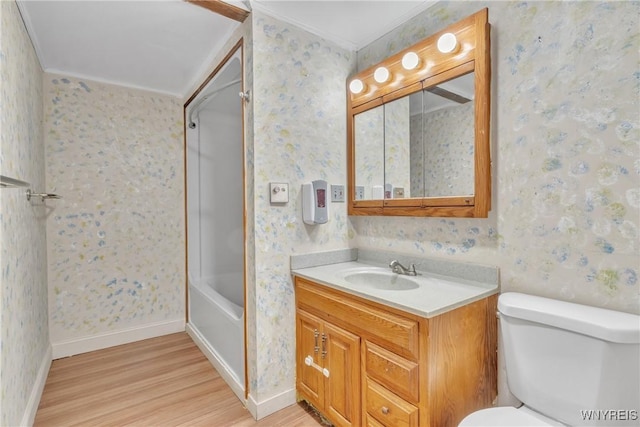 full bathroom with wood-type flooring, toilet,  shower combination, and vanity