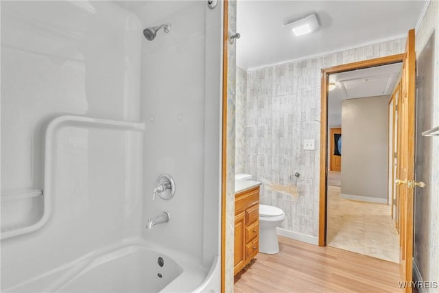 full bathroom with toilet, wood-type flooring, ornamental molding, vanity, and shower / washtub combination