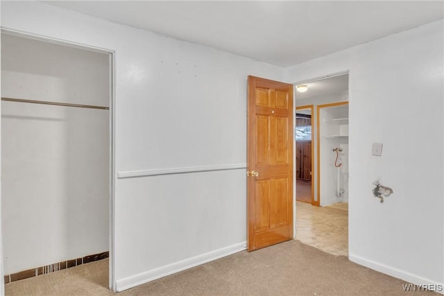 unfurnished bedroom with carpet and a closet