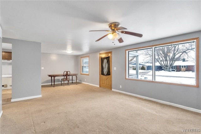 interior space with light colored carpet and ceiling fan