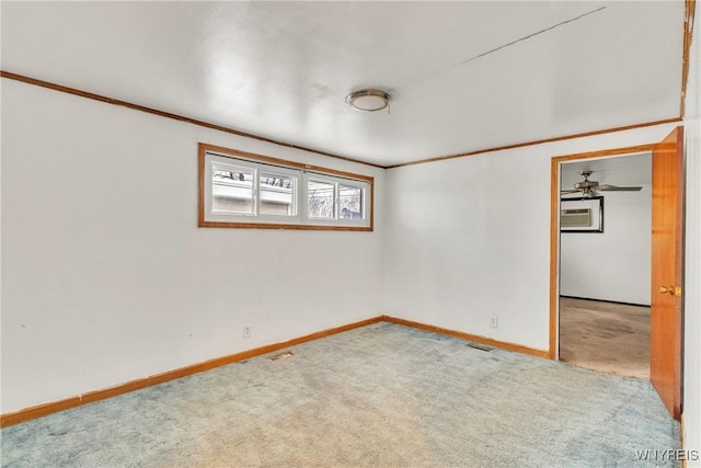 carpeted empty room featuring crown molding and a wall mounted AC