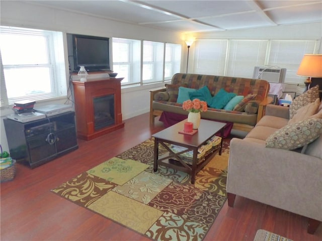 living room with wood-type flooring, a wealth of natural light, and cooling unit