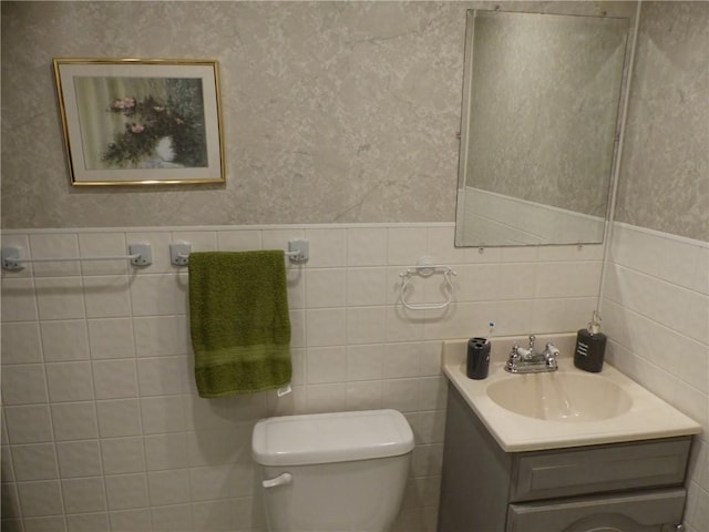 3049 Huggins Rd, Orange, NY 14815 - half bathroom with wallpapered walls, toilet, vanity, wainscoting, and tile walls