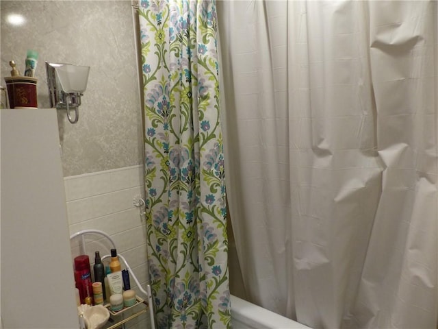3049 Huggins Rd, Orange, NY 14815 - full bathroom featuring tile walls and shower / bathtub combination with curtain