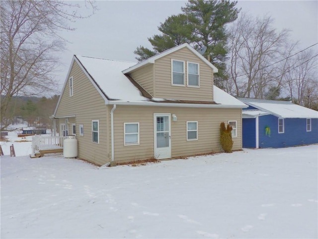 view of snow covered back of property