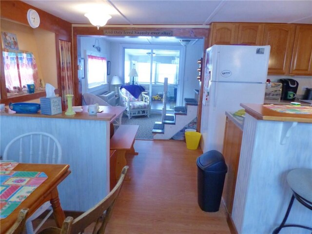 3049 Huggins Rd, Orange, NY 14815 - kitchen featuring freestanding refrigerator, light wood finished floors, brown cabinets, and light countertops