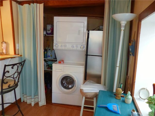 3049 Huggins Rd, Orange, NY 14815 - laundry room with stacked washer / dryer and wood finished floors