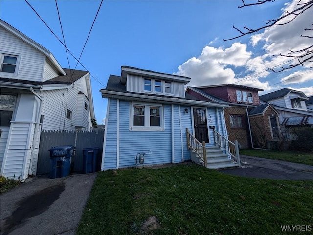 bungalow-style home with a front yard