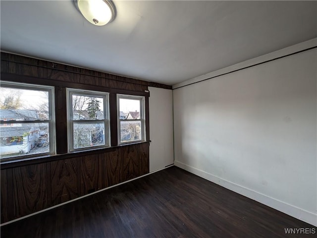 empty room with dark hardwood / wood-style floors