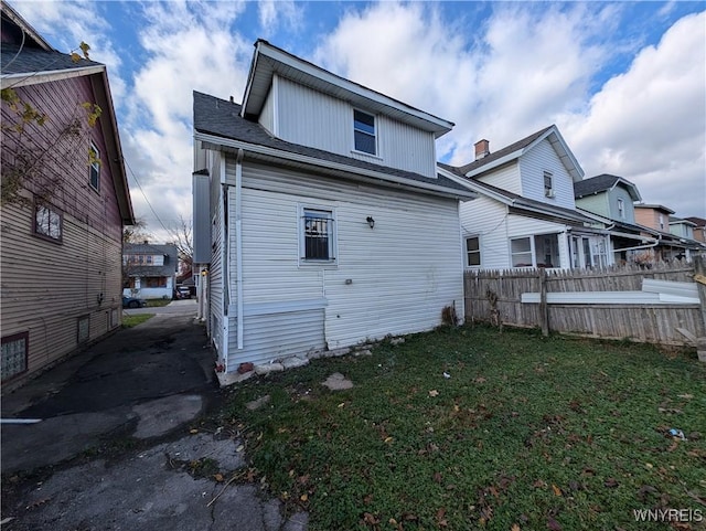 rear view of property with a lawn