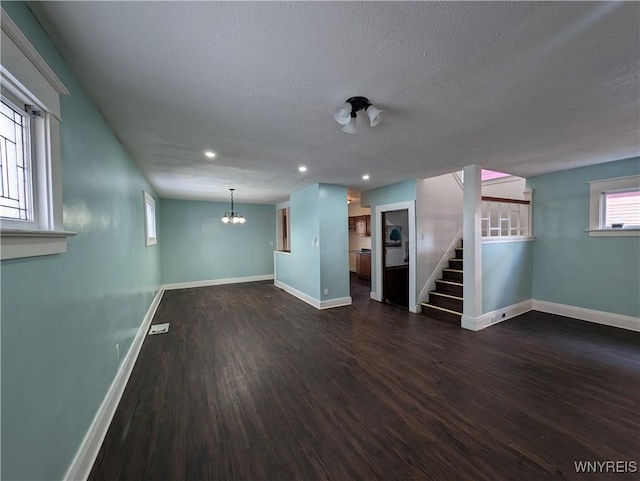 basement with dark hardwood / wood-style floors and a textured ceiling