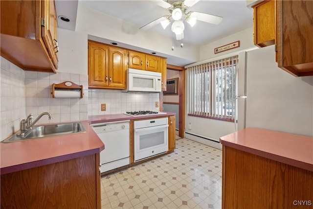 kitchen with sink, white appliances, ceiling fan, baseboard heating, and tasteful backsplash