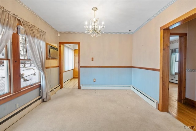 spare room with light colored carpet, a wall unit AC, and a baseboard heating unit