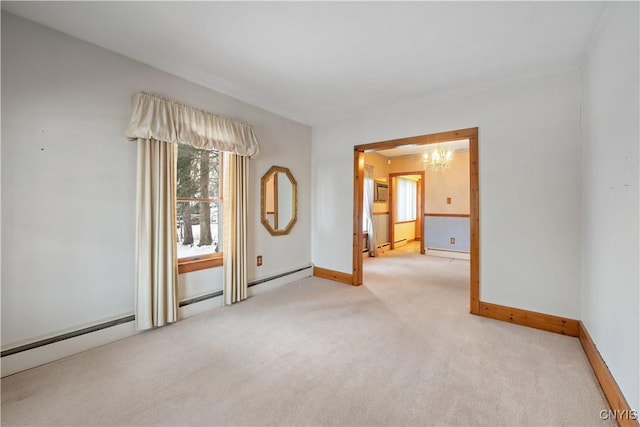 carpeted empty room with a notable chandelier and baseboard heating