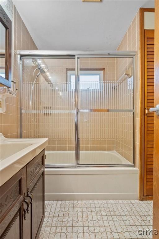 bathroom with vanity, tile patterned floors, and enclosed tub / shower combo