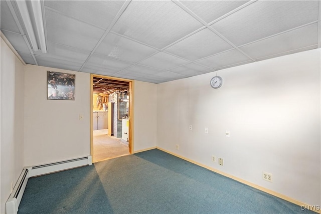 basement with a baseboard radiator, carpet, and a paneled ceiling