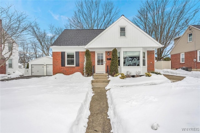 view of front of home with a garage and an outdoor structure